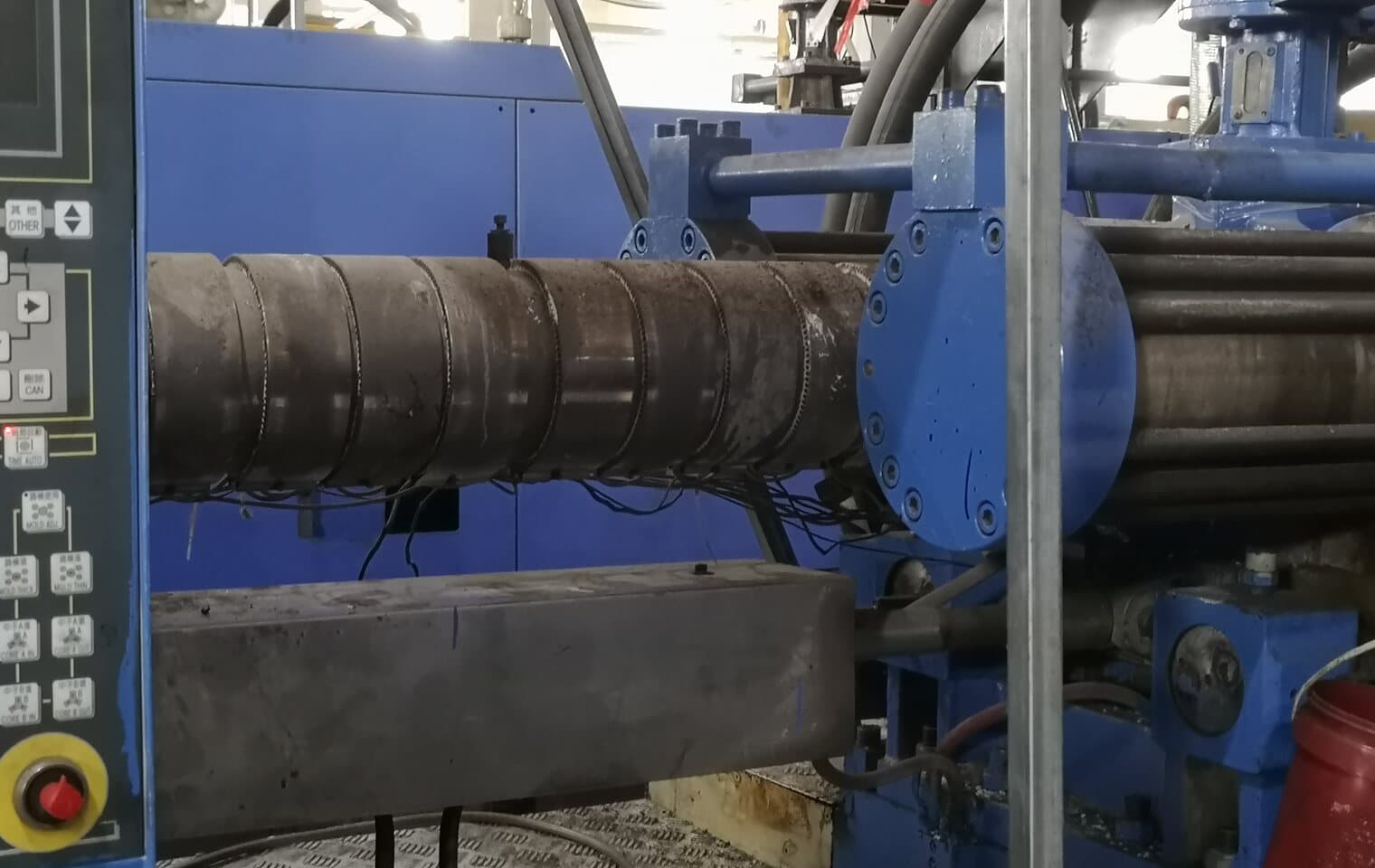 A pipe section clamped in the machine shop while a fitting is worked to the drawing