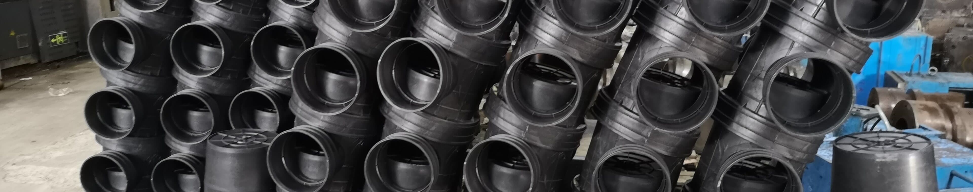 Rows of moulded PE fittings held in the warehouse beside the injection presses
