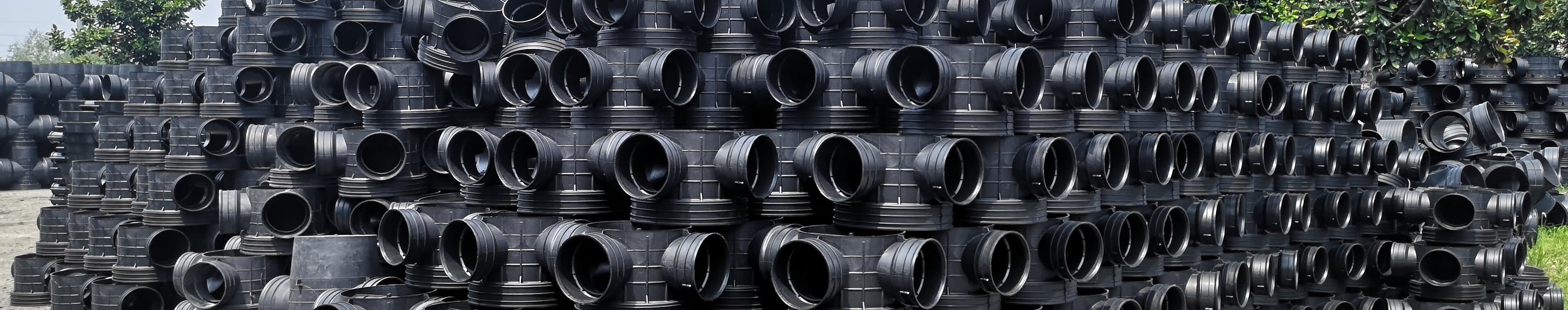 Butt fusion tees, elbows and reducers stacked across the fittings yard