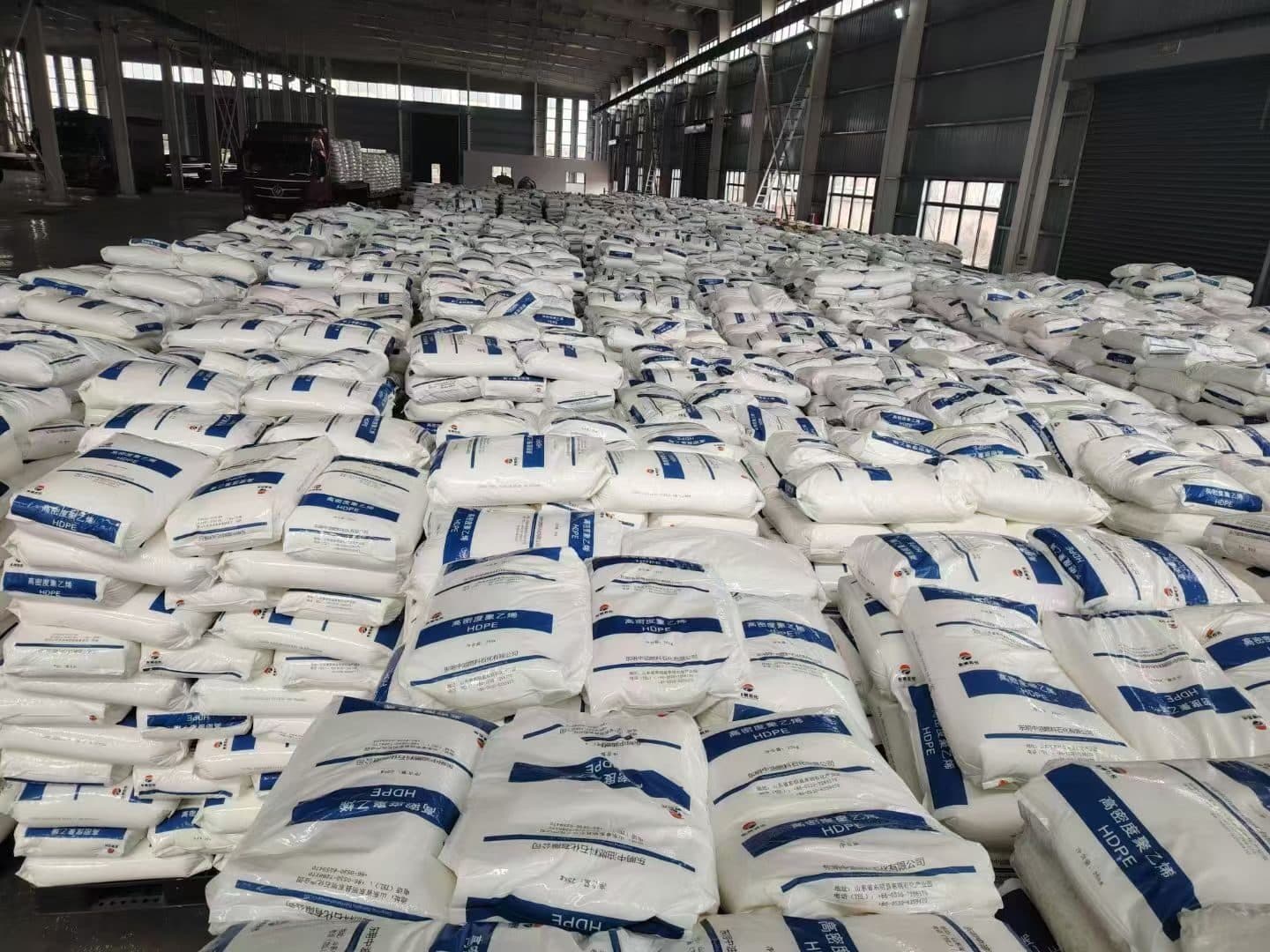 The raw-material store: pallets of bagged HDPE compound stacked across the warehouse floor